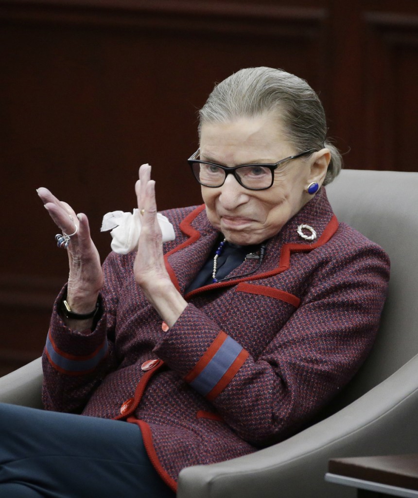 U.S. Supreme Court Justice Ruth Bader Ginsburg claps during a "fireside chat" she participates in at the Roger William University Law School on Tuesday in Bristol, R.I.