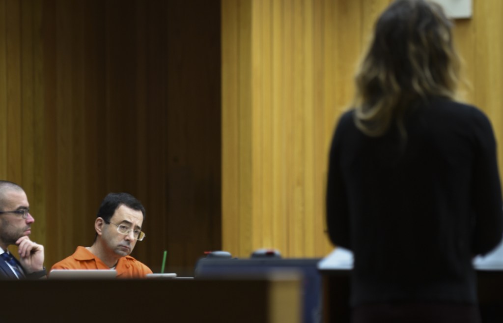 Larry Nassar, second from left, listens as a woman gives her victim impact statement Wednesday in Eaton County Circuit Court in Charlotte, Mich.