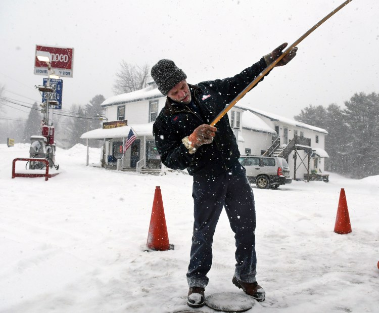 Fabian Oil tanker truck driver Scott Nesbit checks a dip stick at the fuel tanks at the Litchfield Country Store as Thursday’s blizzard moved into Maine. Nesbit delivered 5,000 gallons of gasoline to the store that clerks said ran out Wednesday. Inundated with calls from customers, heating fuel dealers across the state scrambled to meet demand, and several smaller companies said they were looking at backlogs of a week or more for customers who don’t have automatic refill service.
