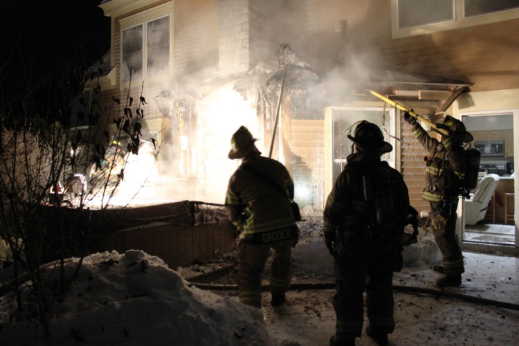 Firefighters from several departments fight a house fire on Waterville's Trafton Road early Wednesday morning.