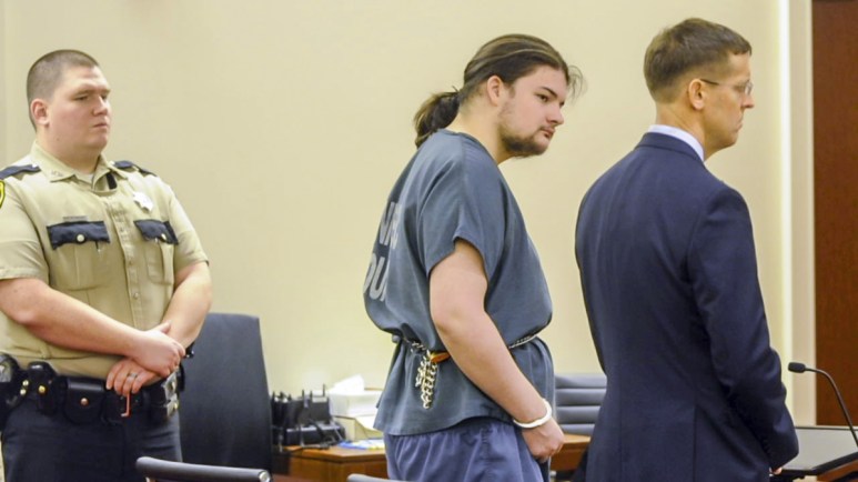 Andrew Balcer, center, stands with his attorney Walter McKeee during his arraignment Friday on two murder chargers and one of animal cruelty in the Capital Judicial Center in Augusta.