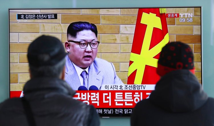 South Koreans watch North Korean leader Kim Jong Un's New Year's speech on a TV monitor at the Seoul Railway Station in Seoul, South Korea, Monday.