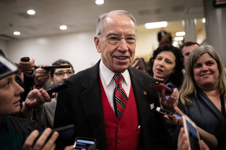 Senate Judiciary Committee Chairman Chuck Grassley, R-Iowa, speaks with reporters at the Capitol in Washington on Thursday. On Thursday, Grassley released some previously recovered texts from the FBI discussing the Clinton email probe that Republicans say call into question whether she had been treated too gently.