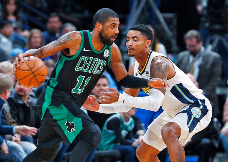 Celtics guard Kyrie Irving drives past Nuggets guard Gary Harris in the first half of Monday night's game in Denver. Irving finished 11 of 17 from the field to lead the Celtics in scoring.