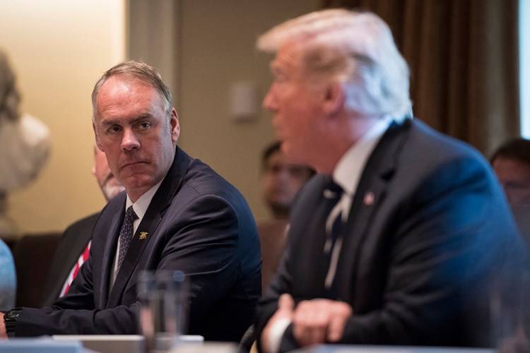Secretary of the Interior Ryan Zinke listens to President Trump during a Cabinet meeting in October. 