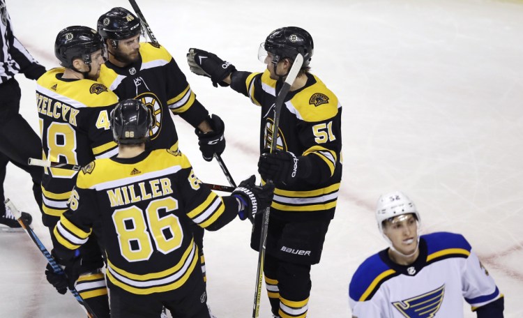 Bruins center David Krejci, second from top left, is congratulated by teammates after his goal in the first period Thursday night in Boston/