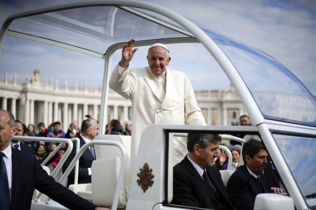 Pope Francis waves as he leaves at the end of his weekly general audience in St. Peter's Square at the Vatican on Wednesday.