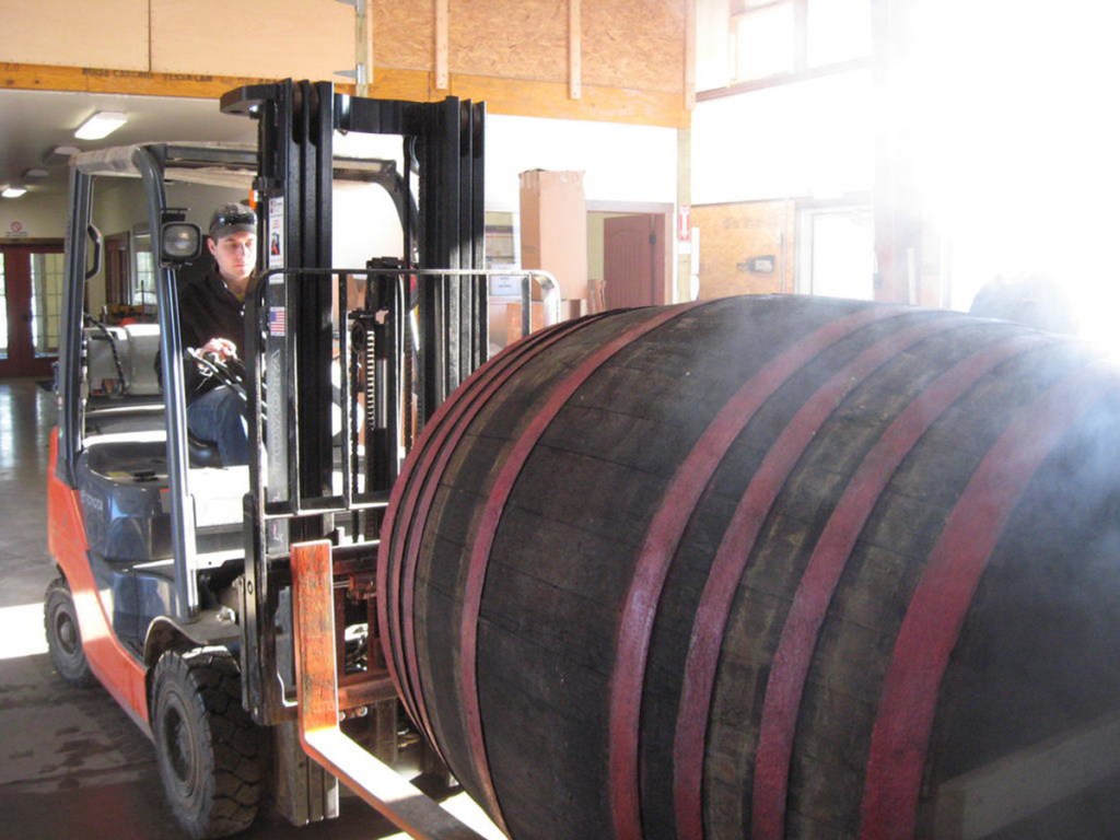 Matt Albrecht moves a 1,000-liter beer barrel to be shipped to Michigan. He plans an expansion that will allow his business to double the number of barrels they currently process.