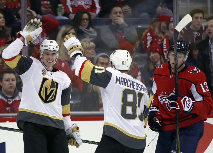 Reilly Smith, left, and Jonathan Marchessault of the Golden Knights celebrate Smith's tying goal in the third period Sunday against the Washington Capitals. Vegas won, 4-3.