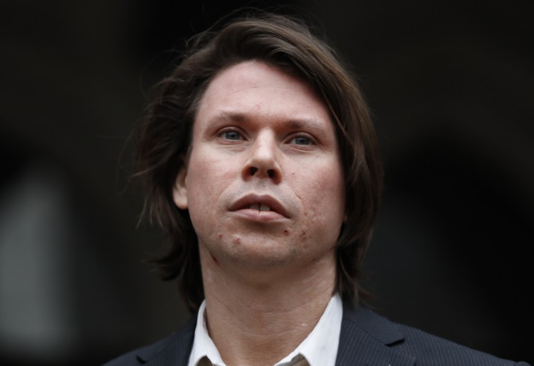 Lauri Love, who is accused of hacking into U.S. government computers, stands outside The Royal Courts of Justice in London on Monday. A British court ruled in Love' favor on his appeal against extradition to the United States, where he faces solitary confinement and a potential 99 year prison sentence.
