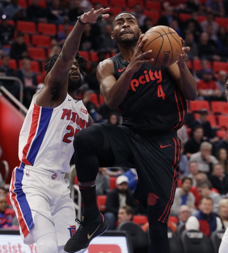 Portland's Maurice Harkless takes a shot while being defended by Detroit's Reggie Bullock during the Pistons' 111-91 win Monday in Detroit.