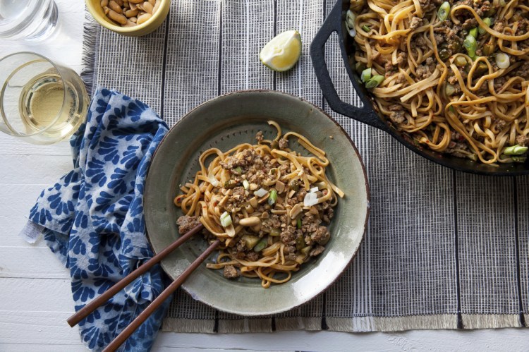 Dan Dan Noodles are basically long, skinny noodles topped with a flavorful sauce built on ground pork and seasoned with pickled vegetables.