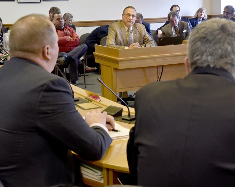 Gov. Paul LePage listens Tuesday during an appearance before the Joint Standing Committee on Taxation in support of L.D. 1629, a bill titled "An Act to Protect the Elderly from Tax Lien Foreclosures," at the State House in Augusta.