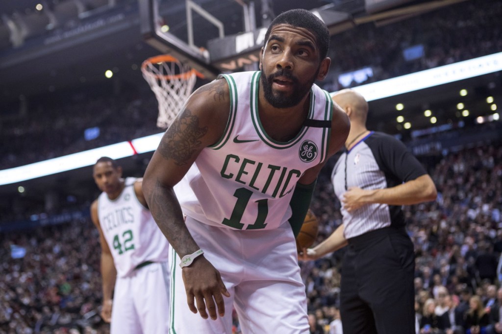 Boston Celtics guard Kyrie Irving gets up from the court during the second half of the team's the Celtics 111-91 loss to the Raptors in Toronto on Tuesday night.