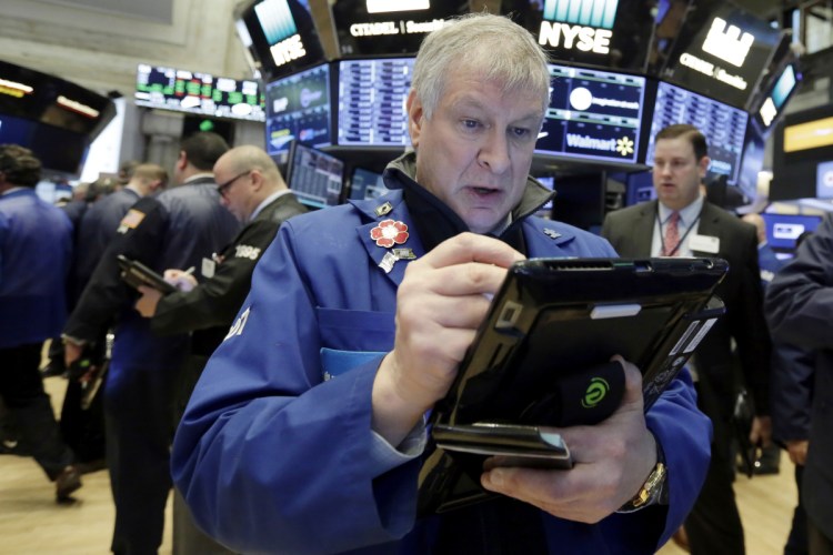 Trader Richard Newman works on the floor of the New York Stock Exchange on Wednesday. Associated Press/Richard Drew