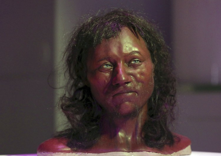 A full facial reconstruction model of a head based on the skull of Britain's oldest complete skeleton is on display during a screening event at The Natural History Museum, in London Wednesday.