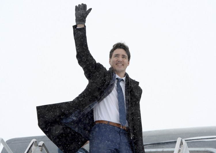Prime Minister Justin Trudeau waves as he boards the government airplane on his way to Chicago, in Ottawa on Wednesday. 
