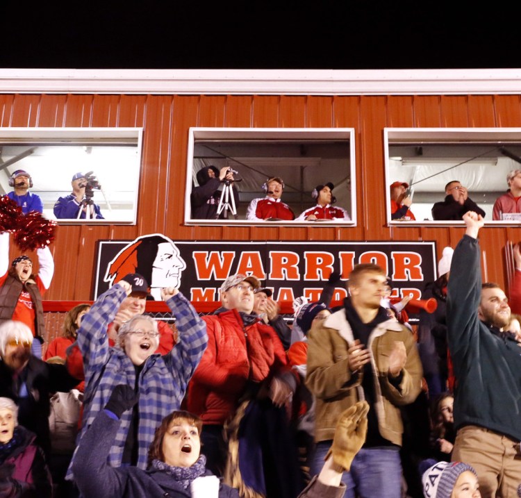 Wells High School fans cheer in front of a press box with a logo of a Native American during a football game last fall. A letter writer says the logo is a generic symbol that is treated with reverence and respect.=