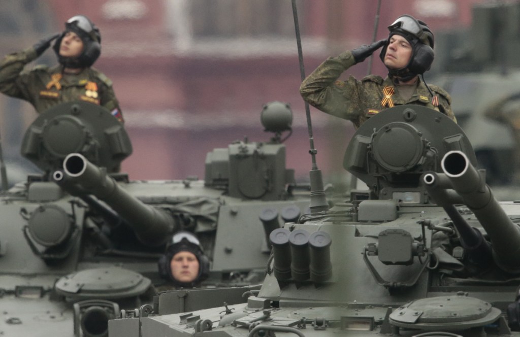 Russian soldiers in tanks drive past a reviewing stand during a parade in Moscow's Red Square last year.