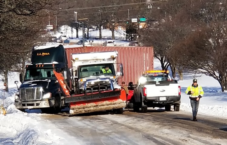 City crews work to free a tractor-trailer that got stuck across Franklin Street in Portland after it spun on ice on Thursday. Traffic was backed up for the morning commute, but was flowing freely by 9:15 a.m.