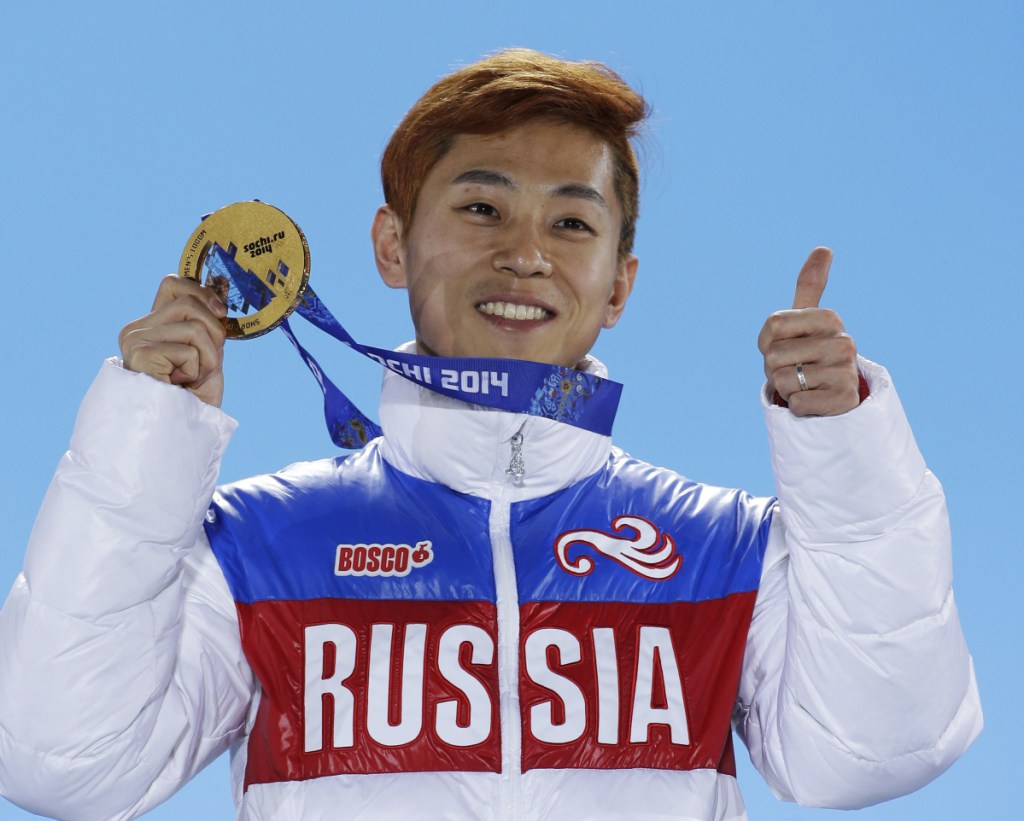 Viktor Ahn of Russia holds his gold medal at the 2014 Winter Olympics in Sochi, Russia. Ahn is among 45 Russian athletes and two coaches who were banned from the Pyeongchang Olympics because of doping concerns in a decision announced Friday, less than nine hours before the opening ceremony.