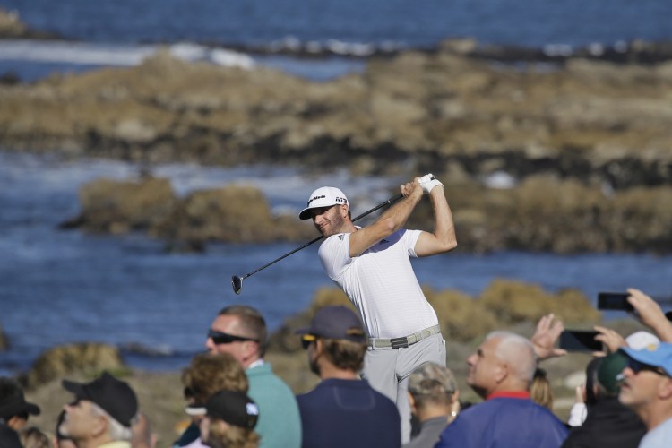 Dustin Johnson follows his shot on the 13th tee Friday at the Monterey Peninsula Country Club Shore Course during the second round of the AT&T Pebble Beach National Pro-Am golf tournament. Johnson is tied for first with Beau Hossler.