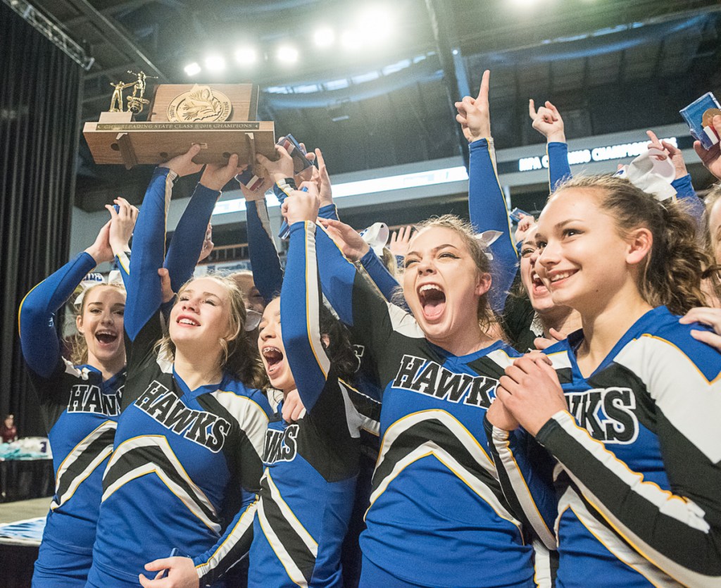 Hermon cheerleaders celebrate after receiving the championship trophy following their victory in the Class B state championships Saturday in Bangor. (Andree Kehn/ Sun Journal)