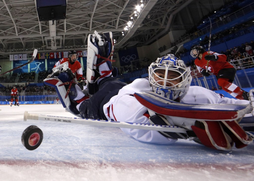South Korea's goalie Shin So-jung, of the combined Koreas team, watches the puck go into the goal off a shot by Phoebe Staenz, of Switzerland, during the second period of a preliminary round game at the 2018 Winter Olympics in Gangneung, South Korea on Saturday.