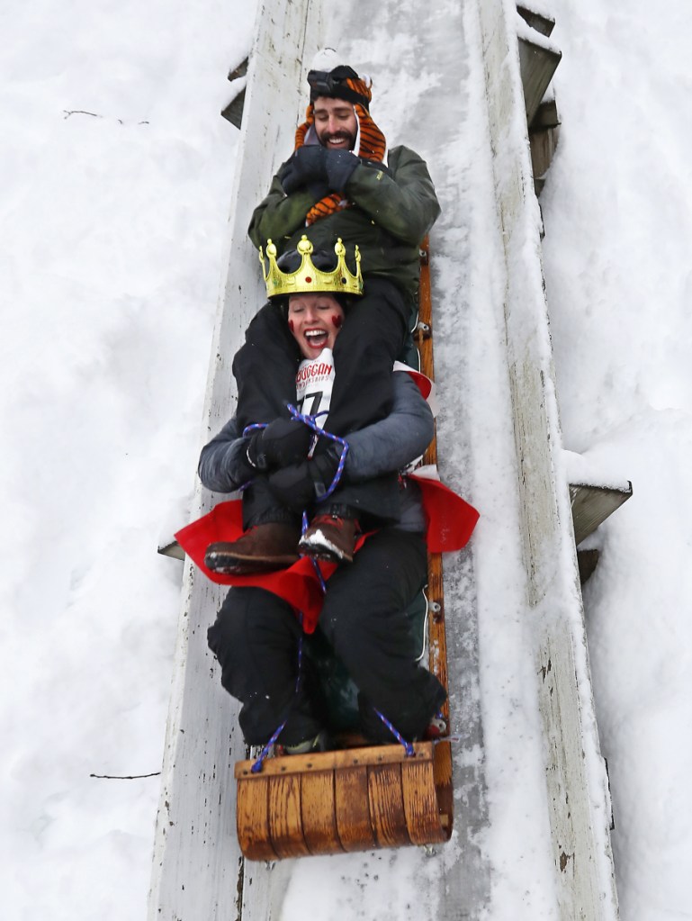 Shannon Bryan shrieks on a toboggan run with teammate Josh Smigelski at the National Toboggan Championships on Saturday in Camden. More than 350 teams are competing. Associated Press/Robert F. Bukaty