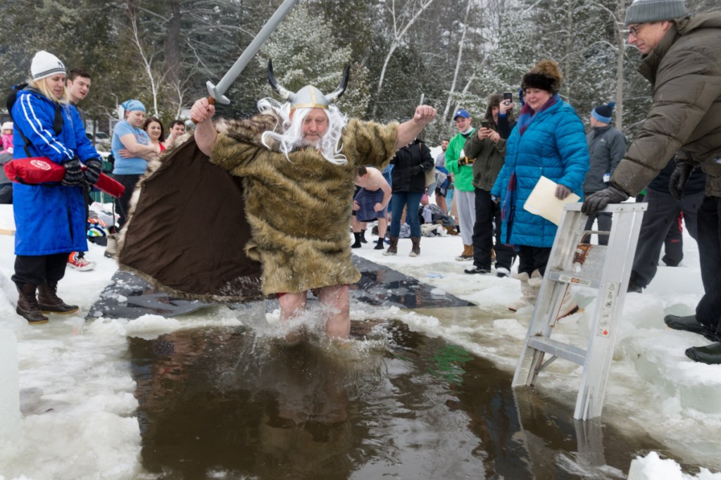 Allen Bernier, dressed as Hagar the Horrible, plunges into frigid water Saturday during the 25th annual Polar Bear Dip.