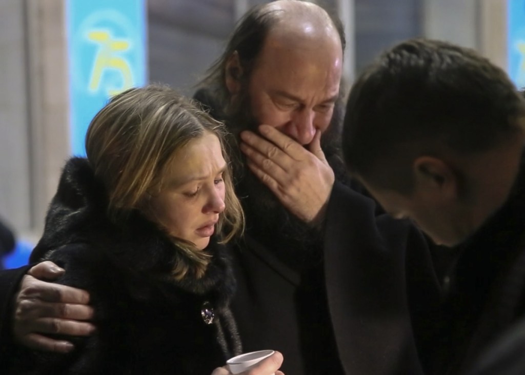 Relatives and friends of those on the Saratov Airlines plane that crashed near Moscow's Domodedovo airport comfort each other while gathering at an airport outside Orsk, Russia, on Sunday, after hearing that the passenger plane went down shortly after taking off.