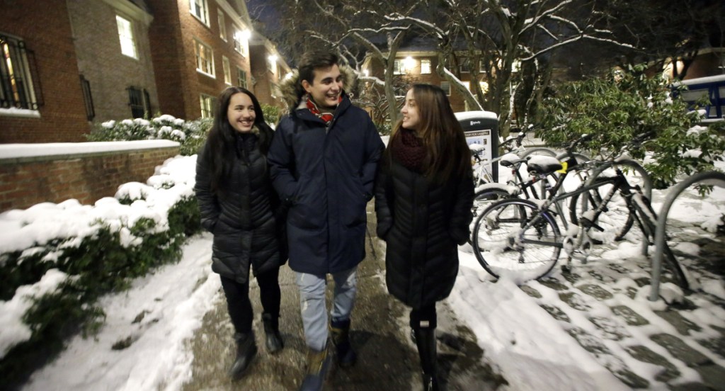 Brown University students from Puerto Rico, from left, Fabiola Guasp of San Juan, Andres Schiavone of Guaynabo, and Estefania Perez of Bayamon, walk back to their dormitory rooms after dinner in a cafeteria on the school's campus in Providence, R.I.