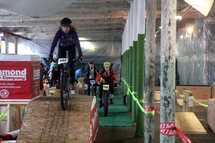 Competitors take part in an indoor mountain bike race inside the old American Woolen Mill in Vassalboro on Sunday. The race was a fundraiser for the "Save the Mill" campaign and was organized by the Central Maine Cycling Club.