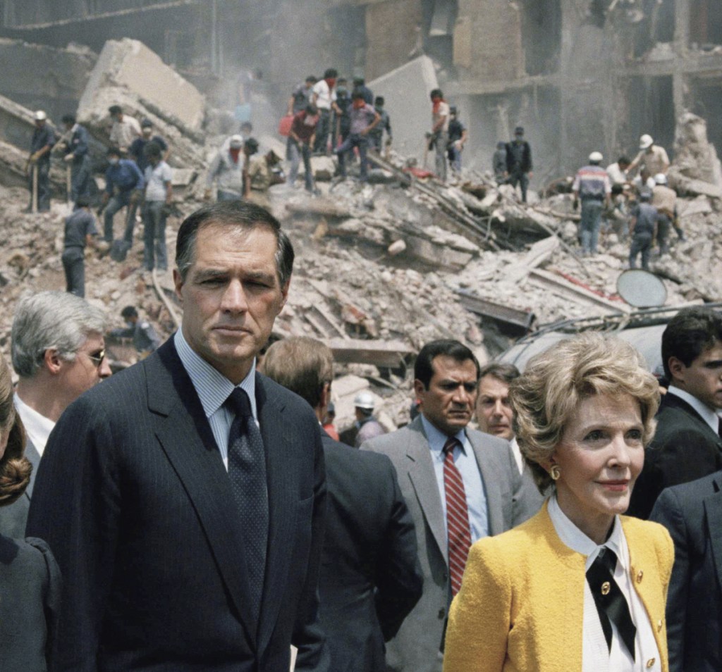 First lady Nancy Reagan and U.S. Ambassador to Mexico John Gavin, left, view earthquake damage in Mexico City in this 1985 photo. Gavin died Friday at 86.