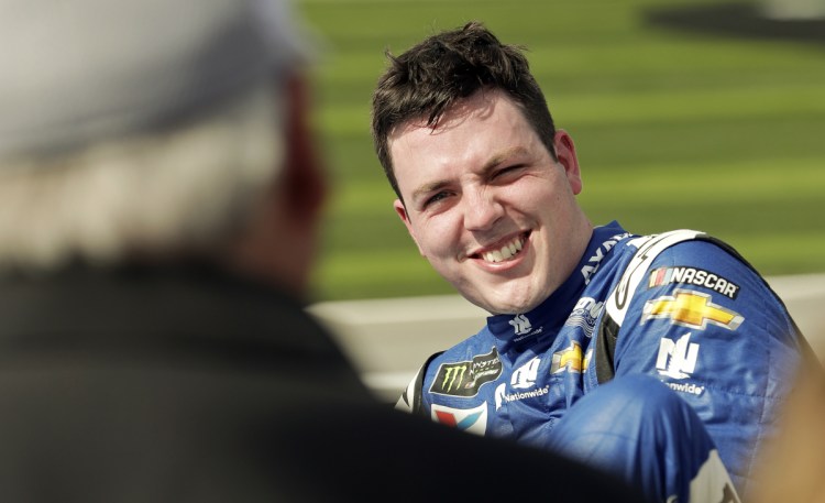 Alex Bowman smiles as he's congratulated by car owner Rick Hendrick after winning the Daytona 500 pole Sunday.