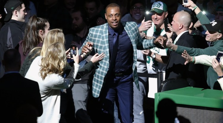 Though it was a blazer instead of a uniform, Paul Pierce still wore green Sunday while coming onto the court for a ceremony to retire his No. 34. Current and past members of the Celtics were among those who joined the crowd in the tribute.