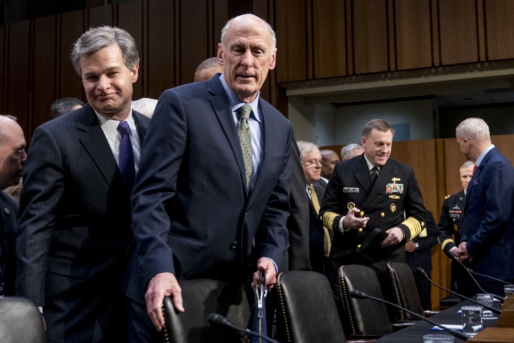 FBI Director Christopher Wray, left, and Director of National Intelligence Dan Coats, second from left, arrive for a Senate Select Committee on Intelligence hearing on worldwide threats on Tuesday in Washington.