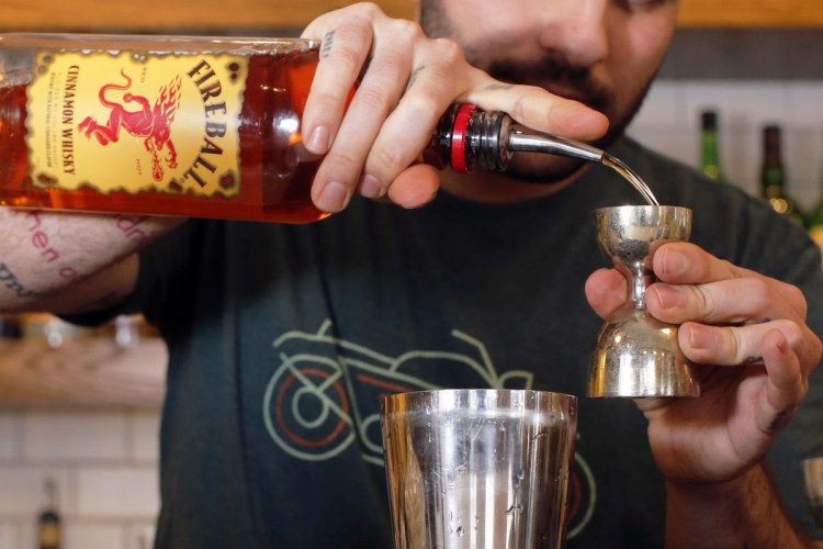 Jaren Rivas, bar manager at Tipo, mixes cocktails made with Allen's Coffee Flavored Brandy and Fireball Cinnamon Whiskey.