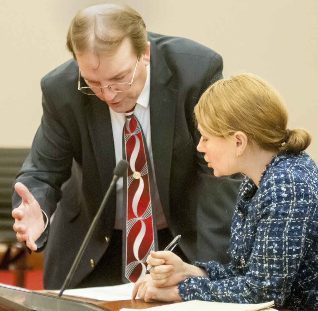 Brent Davis, Gov. Paul LePage's chief legal counsel, and Tracy Collins, the attorney for Washington County commissioners, confer before a brief court hearing Wednesday.