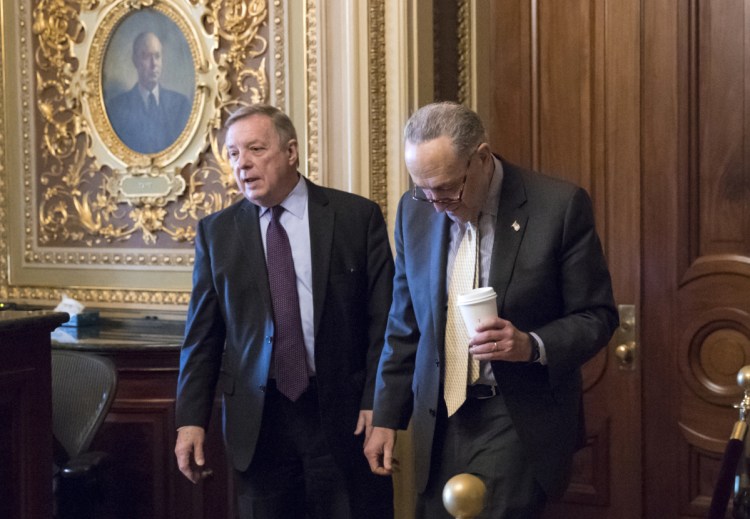 Sen. Dick Durbin, D-Ill., left, and Senate Minority Leader Chuck Schumer, D-N.Y., walk together outside the chamber during debate in the Senate on immigration, at the Capitol in Washington on Wednesday. Schumer said on the Senate floor that "the one person who seems most intent on not getting a deal is President Trump."