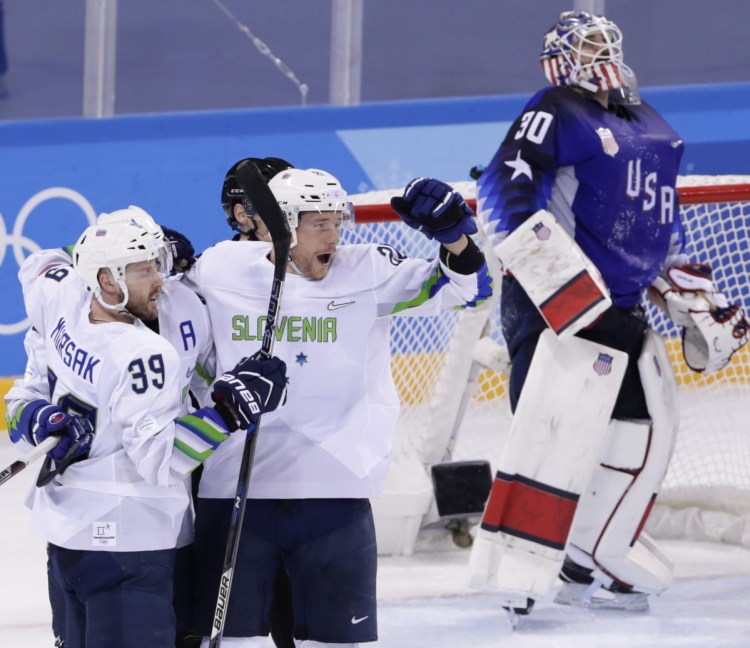 USA goalie Ryan Zapolski can only look at the scoreboard after Jan Mursak scores in OT to give Slovenia a 3-2 win. The U.S. blew a two-goal lead in its first game in South Korea.