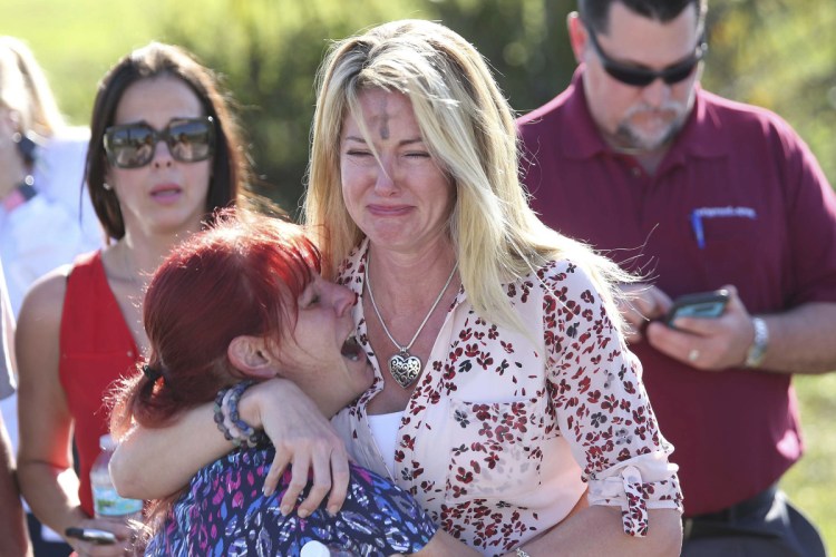 Distraught parents wait for news Wednesday outside Marjory Stoneman Douglas High School in Parkland, Fla., where 17 people were killed in one of the nation's most deadly school shootings. Among high-income nations, 91 percent of the children under age 15 who have been shot to death are American.