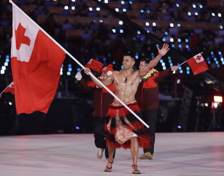 Pita Taufatofua carries the flag of Tonga during the opening ceremony of the 2018 Winter Olympics in Pyeongchang, South Korea on Friday.