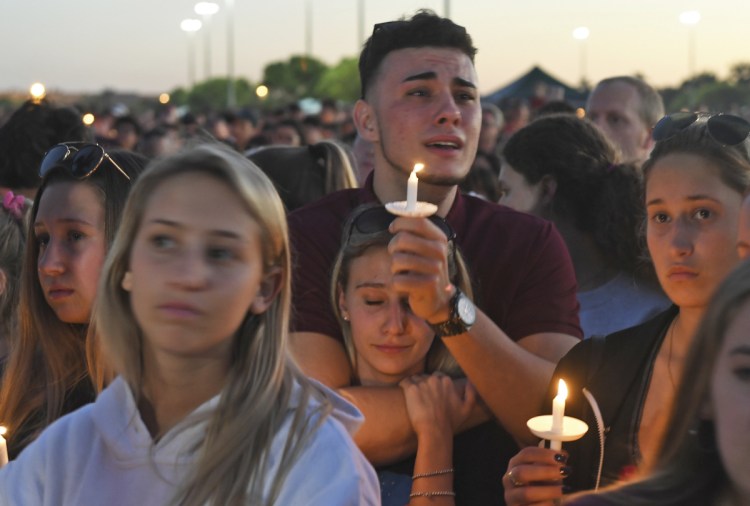 Mourners gather at a vigil that was held for the victims of the shooting at Marjory Stoneman Douglas High School on Thursday.