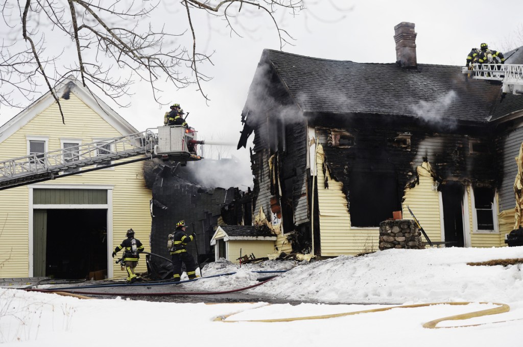 Firefighters battle a two-alarm fire at a home on Chicopee Road in Standish on Friday.