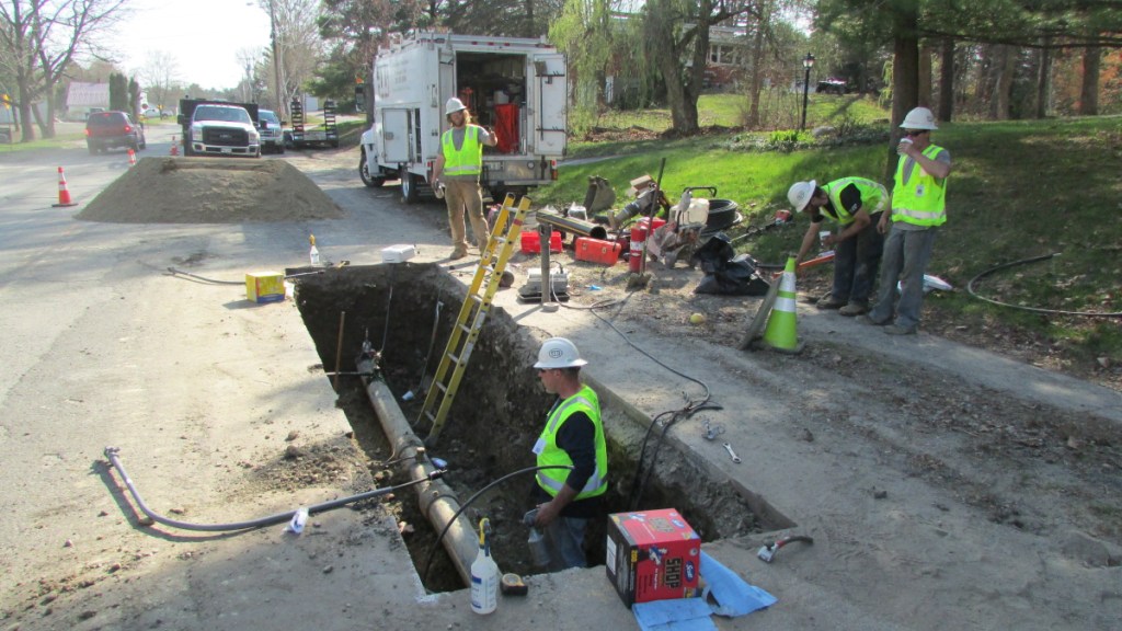 Employees from ETTI, a utilities construction company, work on a Summit Natural Gas line in May 2015 in Waterville to replace a part that had been incorrectly installed. Summit says it will break ground this spring on a project to expand its services and infrastructure to Sidney after striking a deal with asphalt and aggregate materials producer Pike Industries.