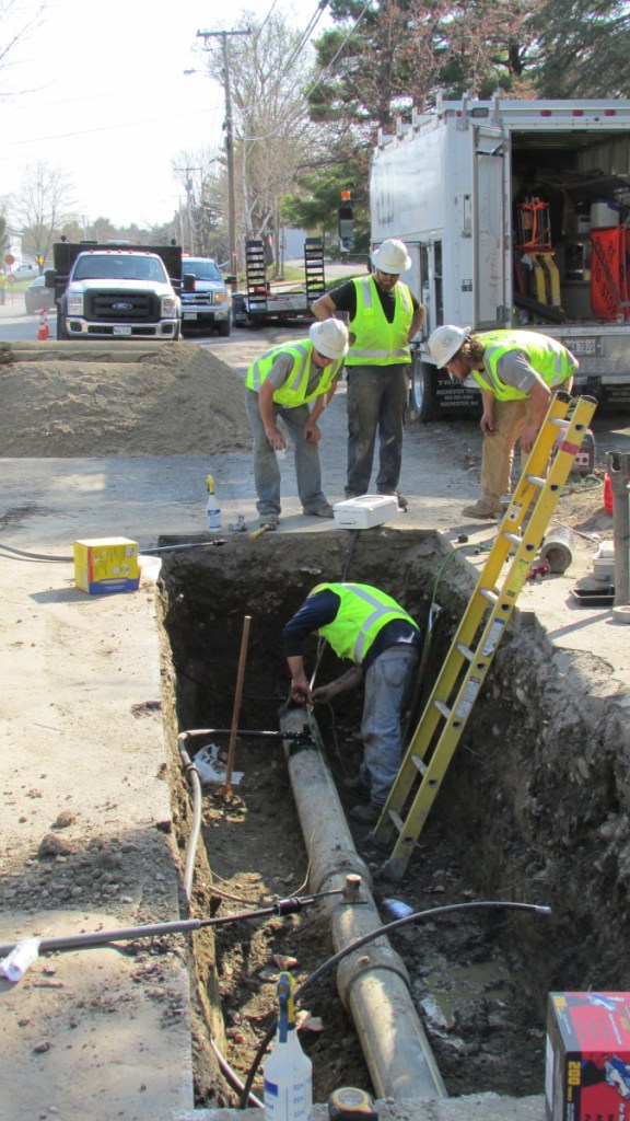 Employees from ETTI, a utilities construction company, work on a Summit Natural Gas line in May 2015 in Waterville to replace a part that had been incorrectly installed. Summit says it will break ground this spring on a project to expand its services and infrastructure to Sidney after striking a deal with asphalt and aggregate materials producer Pike Industries.