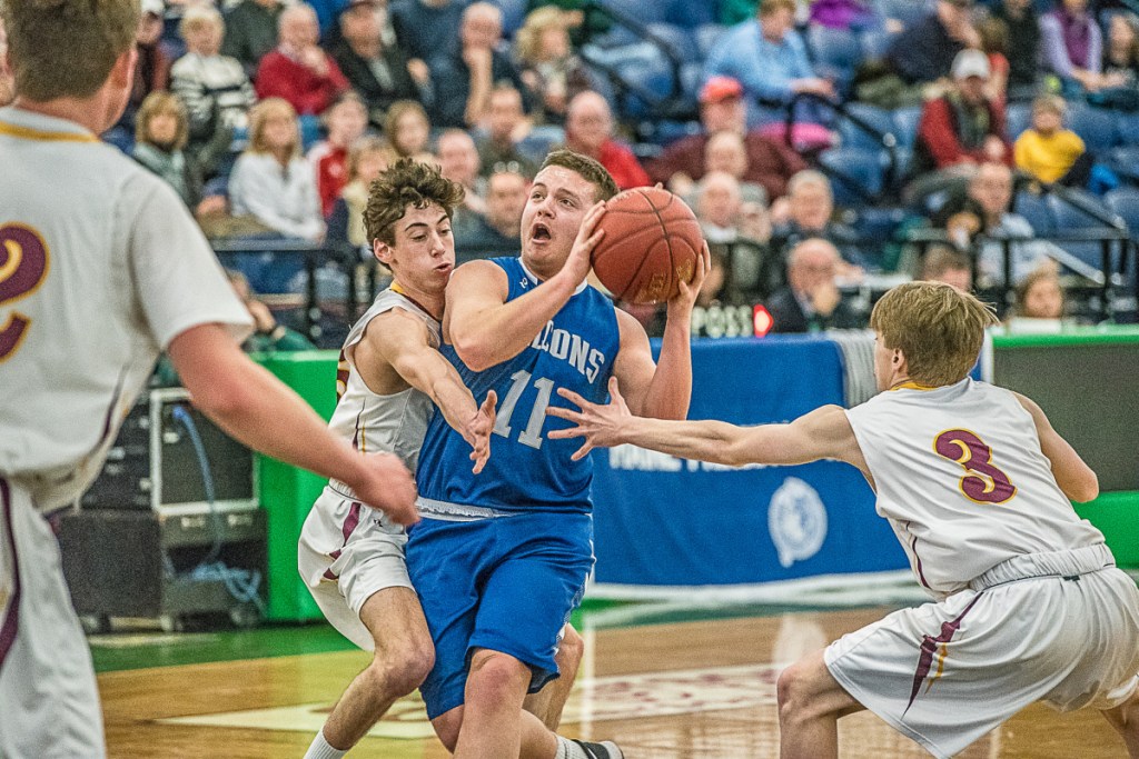 Mountain Valley's Michael Pare takes a shot as Liam Jacobson and Nathan Mullen of Cape Elizabeth play defense during Saturday's game at the Portland Expo. Cape Elizabeth won the game, 47-31.