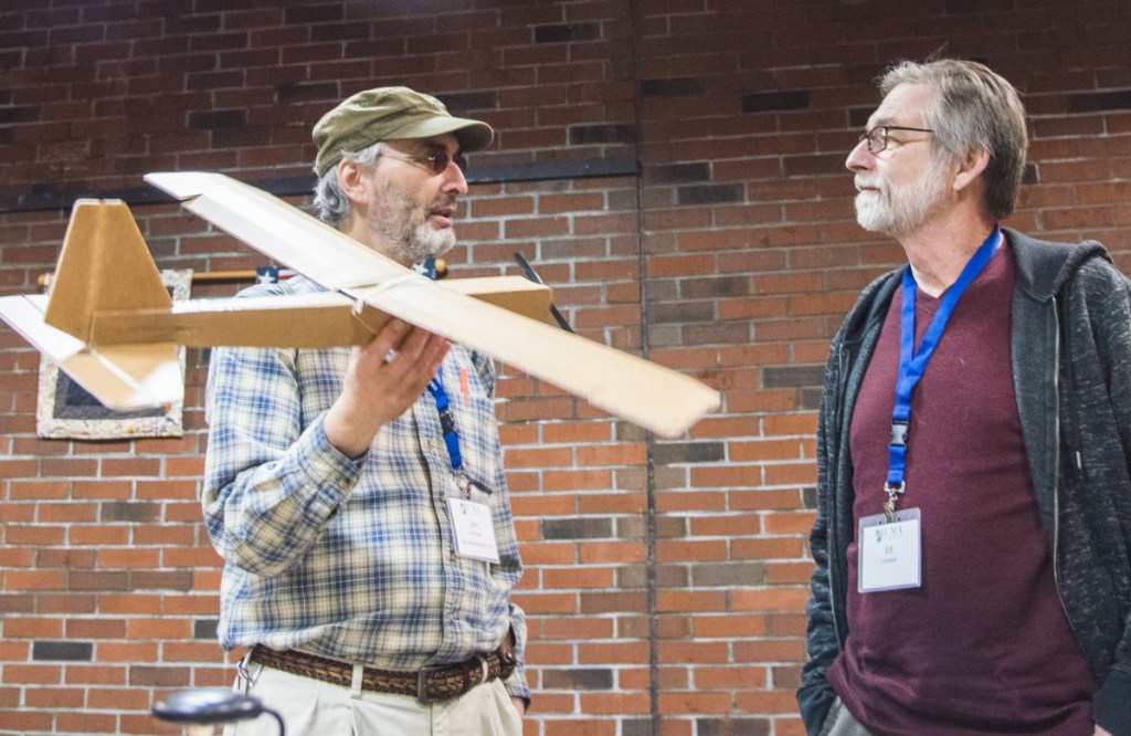 Jon Silverman, left, of Augusta, a recently certified FAA drone pilot, holds a drone made of cardboard Saturday while speaking to Ed Campbell, a land surveyor from Londonderry, N.H.