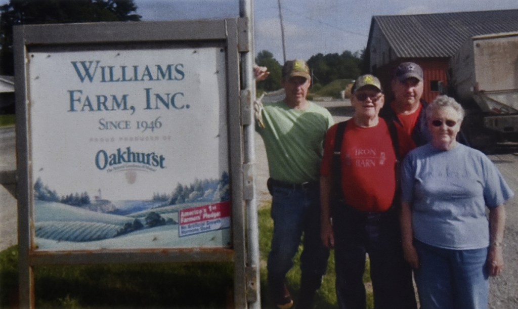 The Williams Farm supplies 30,000 pounds of milk a day to Oakhurst Dairy. Harvey and Jean are in front, and behind are current owners Richard Williams, left, and brother Andy.